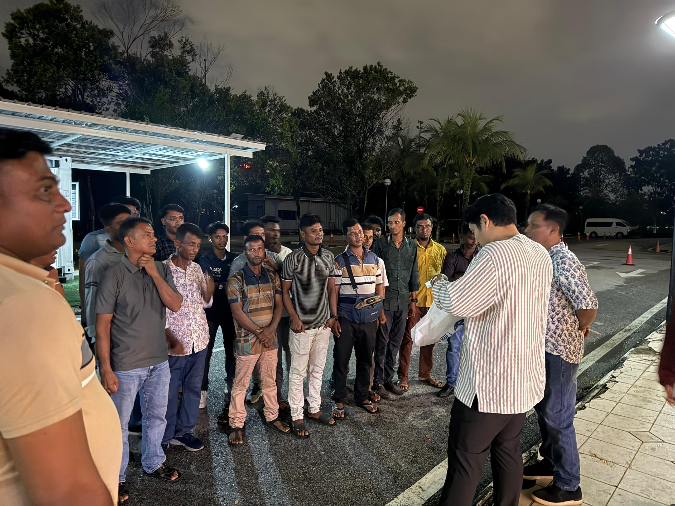 Najib Hamidin speaking with members of his operating team on site at night